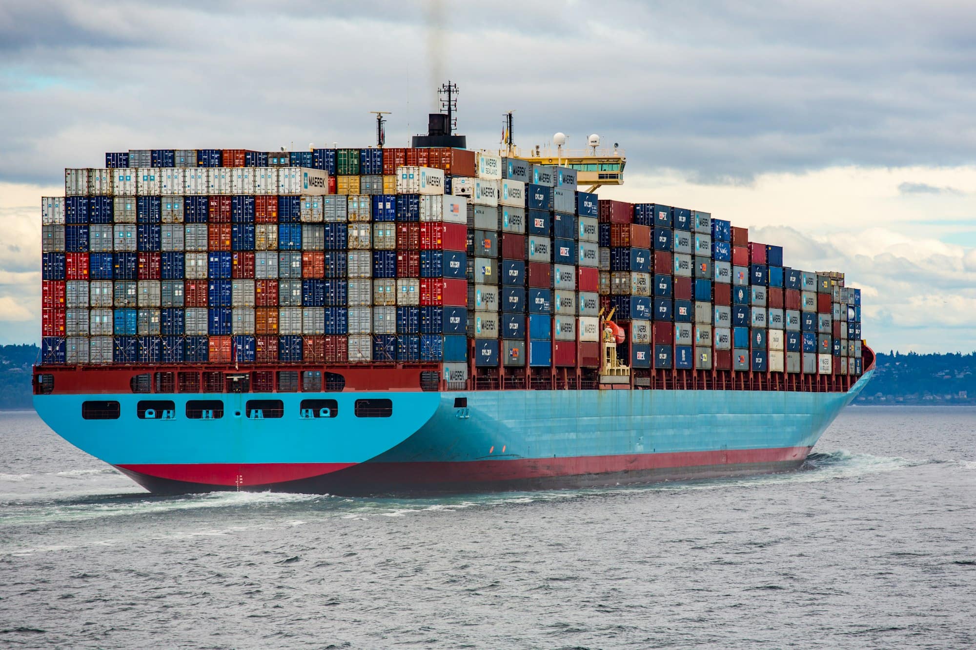 A loaded container vessel under way in open water.